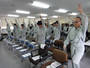Employees practicing accidental fall prevention exercises at ELASTOMIX CO.,LTD